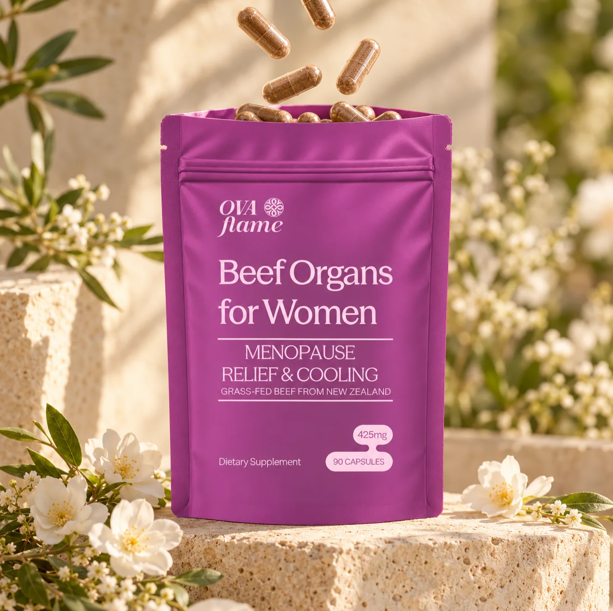OVA flame Menopause Relief & Cooling – pouch, open, capsules falling into it, white flowers